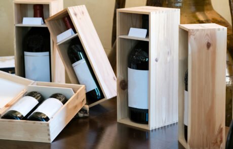 Wine bottles on the wooden shelf in store. Wine cellar testing at the storage.